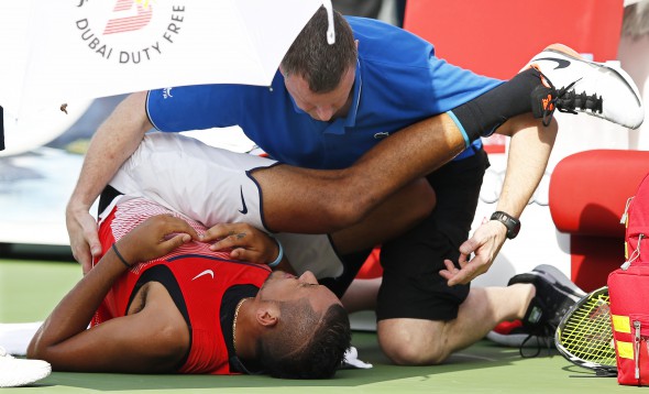 epa05180036 Nick Kyrgios of Australia receives treatment during his quarter final match against Tomas Berdych of the Czech Republic at the Dubai Duty Free Tennis ATP Championships in Dubai, United Arab Emirates, 25 February 2016. EPA/ALI HAIDER